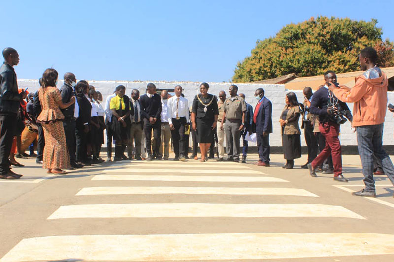 Kitwe Mayor Mpansa Mwaya crosses the newly installed zebra crossing at Chimwemwe Secondary School